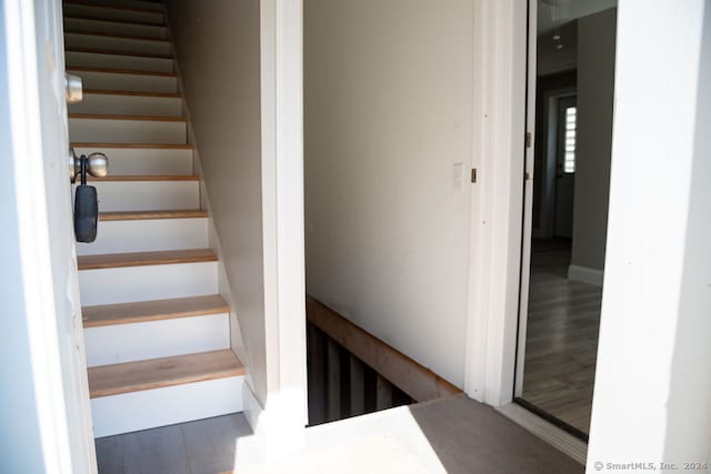 stairs with hardwood / wood-style flooring