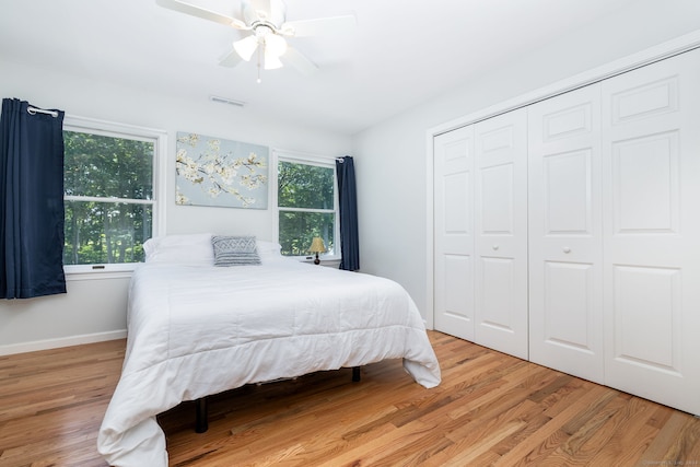 bedroom featuring ceiling fan, a closet, and light hardwood / wood-style flooring