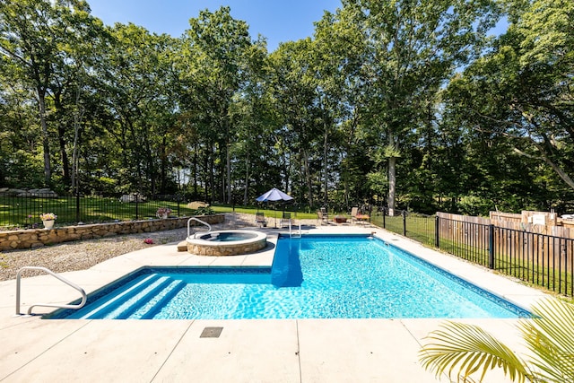 view of swimming pool with an in ground hot tub and a patio