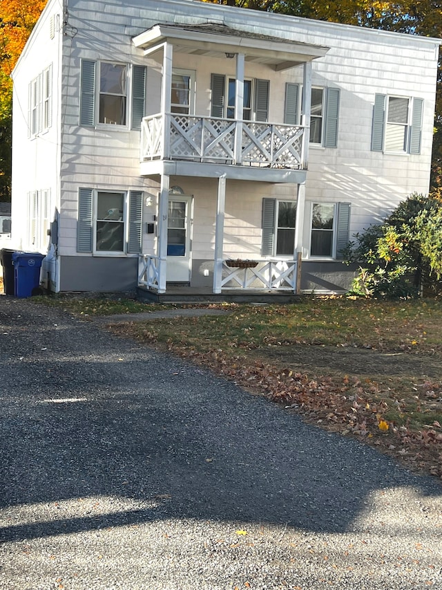 view of front facade featuring a balcony and covered porch