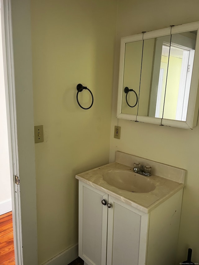 bathroom with vanity and hardwood / wood-style flooring