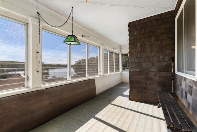 unfurnished sunroom featuring plenty of natural light and a water view