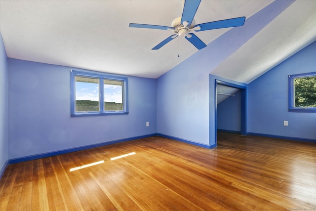 bonus room featuring plenty of natural light, ceiling fan, vaulted ceiling, and hardwood / wood-style flooring