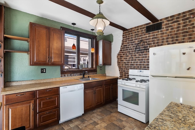 kitchen with white appliances, sink, hanging light fixtures, brick wall, and beam ceiling