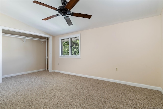 unfurnished bedroom featuring vaulted ceiling, a closet, ceiling fan, and carpet