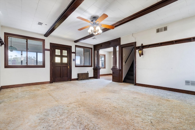 carpeted entryway with radiator, plenty of natural light, beam ceiling, and ceiling fan