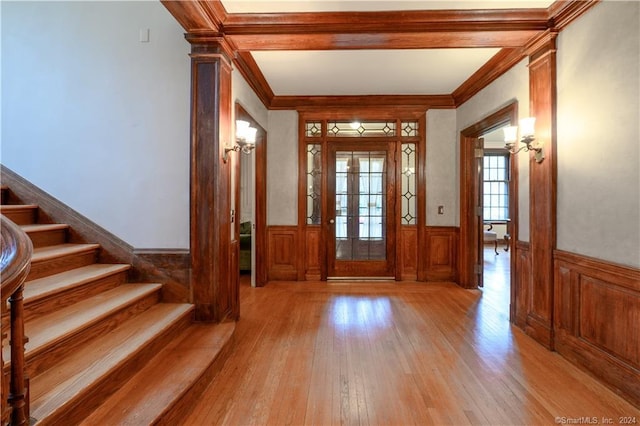 entryway featuring ornamental molding and light hardwood / wood-style floors