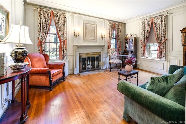 living room with ornamental molding, a wealth of natural light, and hardwood / wood-style floors