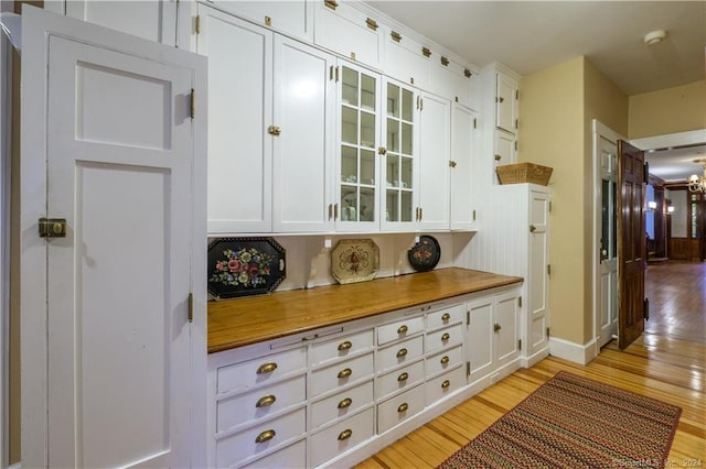 kitchen with white cabinets and light hardwood / wood-style floors