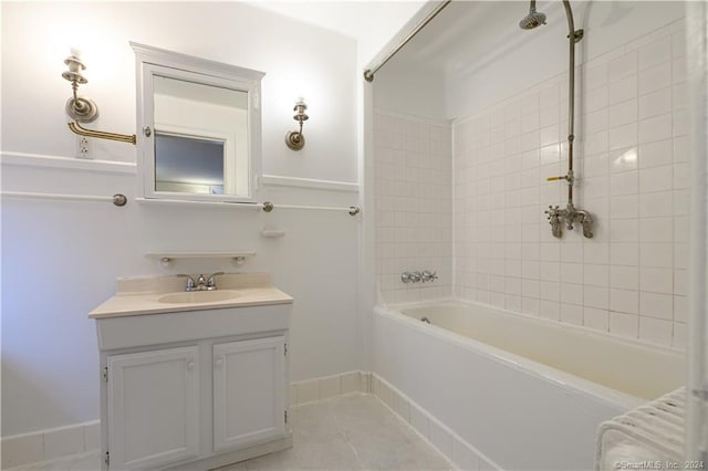 bathroom featuring radiator heating unit, vanity, tiled shower / bath, and tile patterned flooring