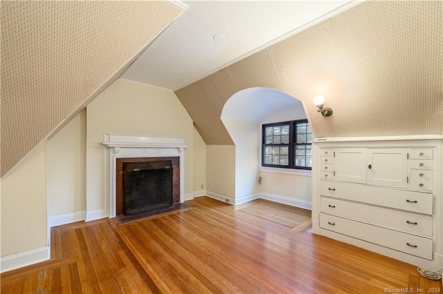 additional living space featuring lofted ceiling and wood-type flooring