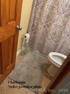 bathroom with tile patterned floors and toilet