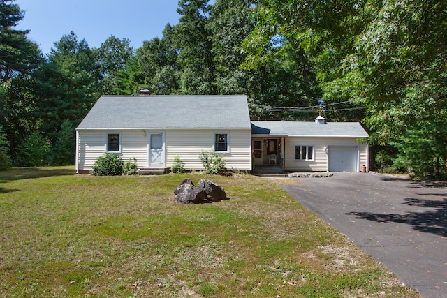 ranch-style house with a front yard and a garage