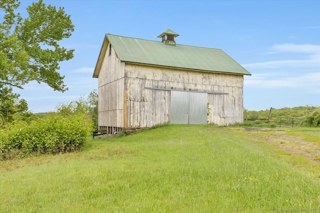 view of outdoor structure with a lawn