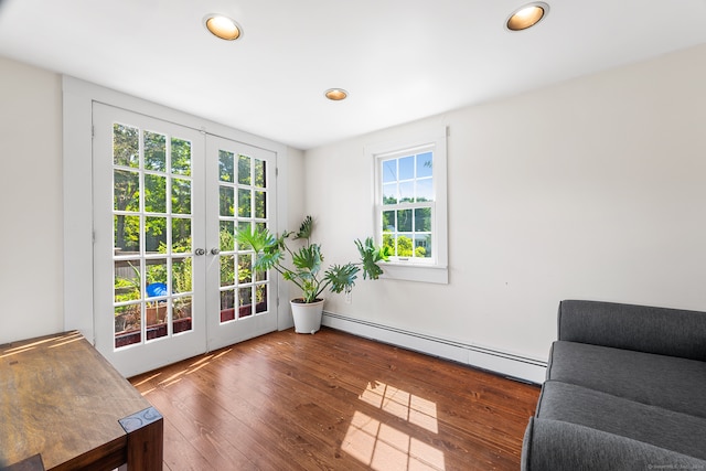 interior space featuring baseboard heating, dark hardwood / wood-style floors, and french doors