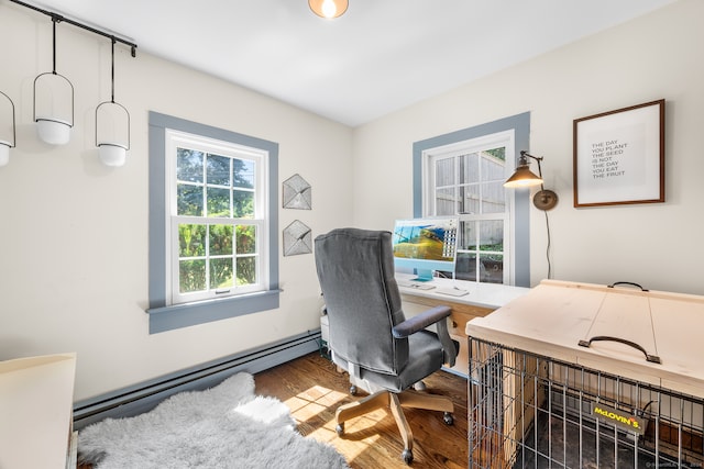 office area with wood-type flooring and a baseboard radiator