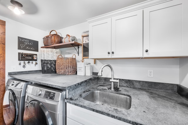 laundry area featuring cabinets, sink, and washing machine and dryer