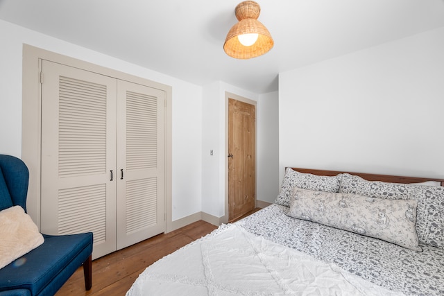 bedroom featuring hardwood / wood-style floors and a closet