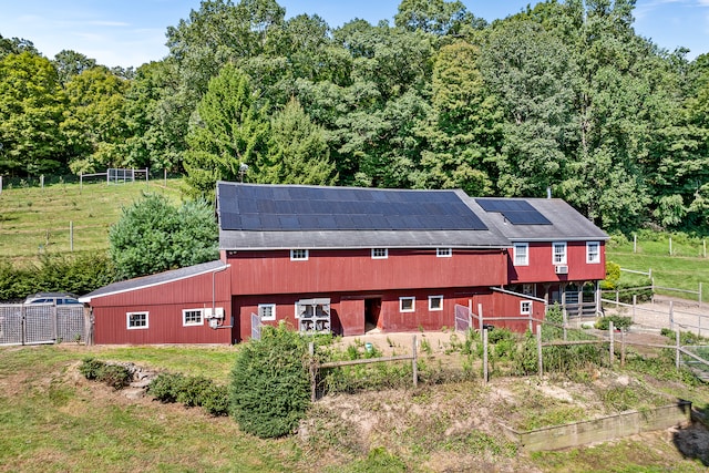 exterior space with an outdoor structure and solar panels