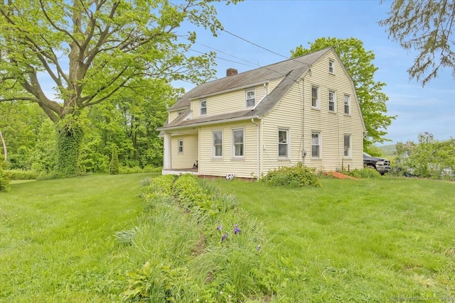 view of side of home featuring a lawn