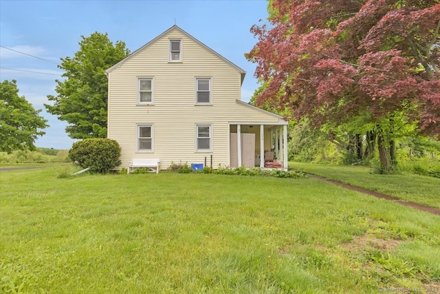 back of house featuring a yard