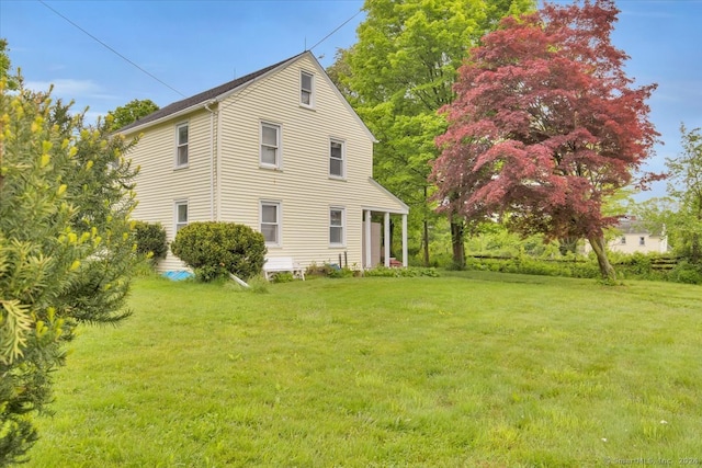 view of home's exterior featuring a yard