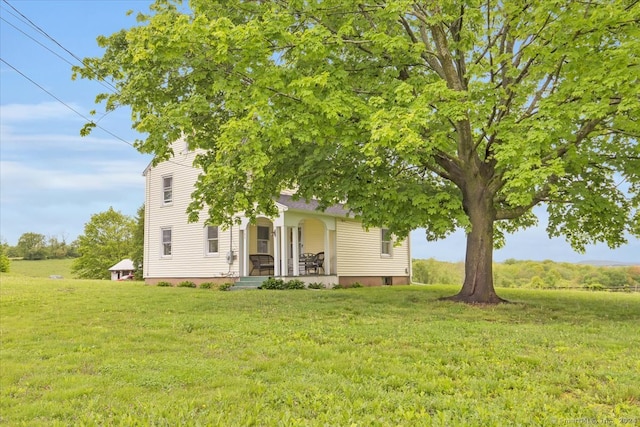 exterior space with covered porch and a front lawn