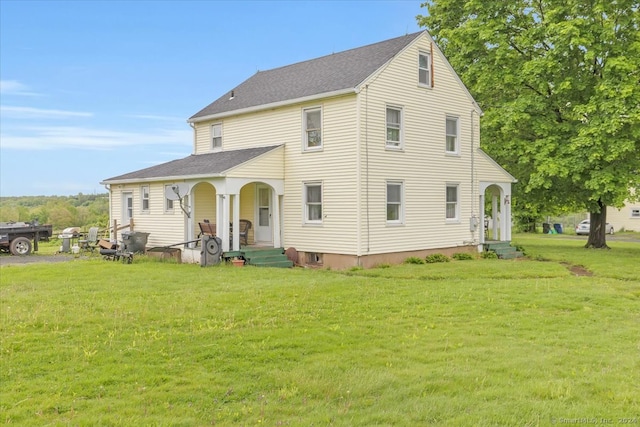 rear view of house with a yard