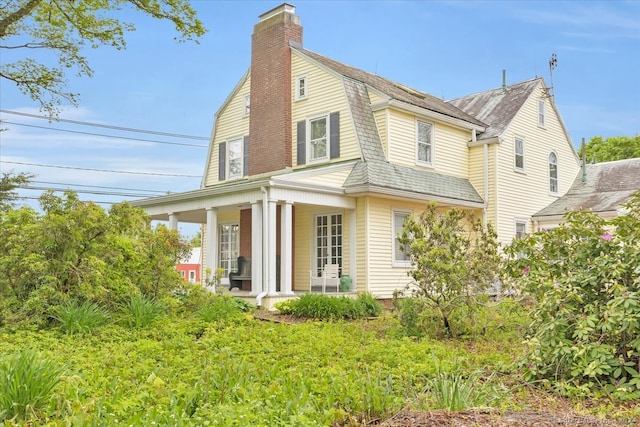 back of property with a porch