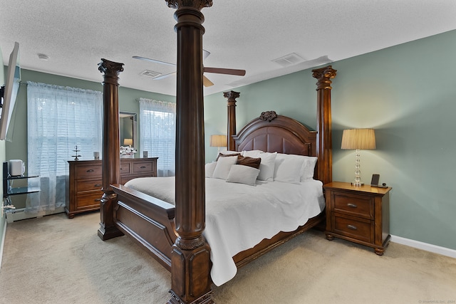 carpeted bedroom with a textured ceiling and ceiling fan