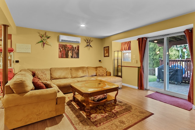 living room featuring light hardwood / wood-style floors and a wall mounted air conditioner