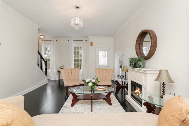 living room featuring hardwood / wood-style floors, a notable chandelier, and ornamental molding