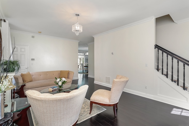 living room with dark hardwood / wood-style floors, a chandelier, and ornamental molding