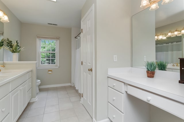 bathroom featuring tile patterned flooring, vanity, toilet, and curtained shower