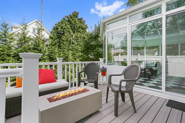 wooden terrace featuring an outdoor fire pit