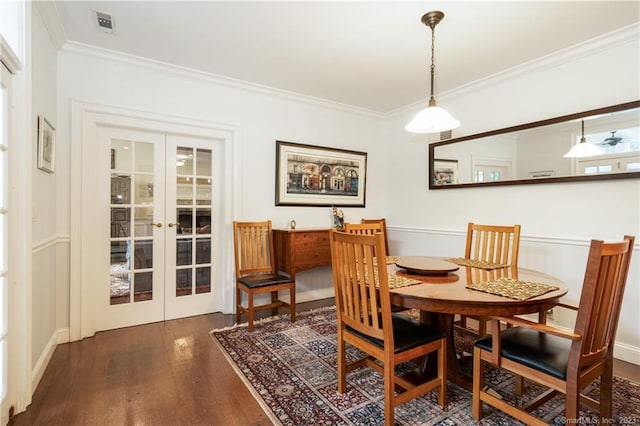 dining room featuring crown molding, french doors, and dark hardwood / wood-style flooring