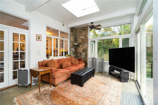 interior space with wooden ceiling, a skylight, beam ceiling, and ceiling fan