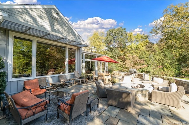 view of patio / terrace featuring an outdoor living space with a fire pit