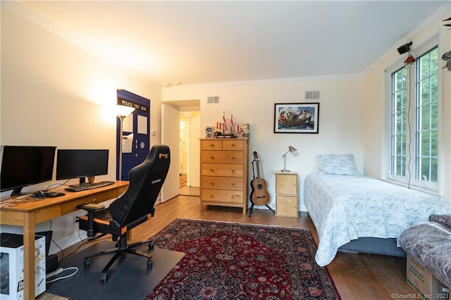 bedroom featuring hardwood / wood-style floors, access to exterior, and crown molding