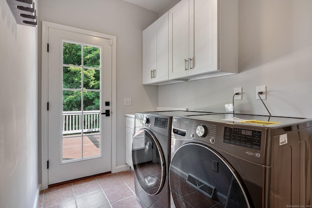 laundry area with cabinets, separate washer and dryer, and light tile patterned floors