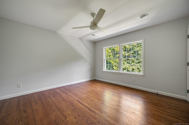 empty room featuring dark hardwood / wood-style floors and ceiling fan