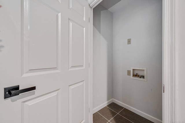 clothes washing area featuring hookup for a washing machine and dark tile patterned floors