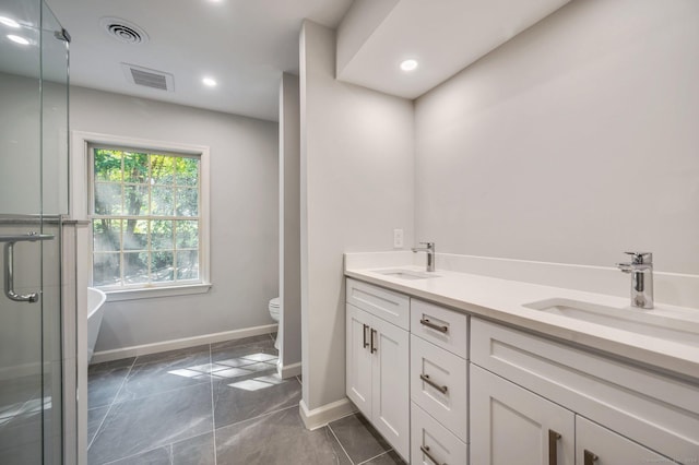 bathroom with vanity, toilet, and a shower with shower door