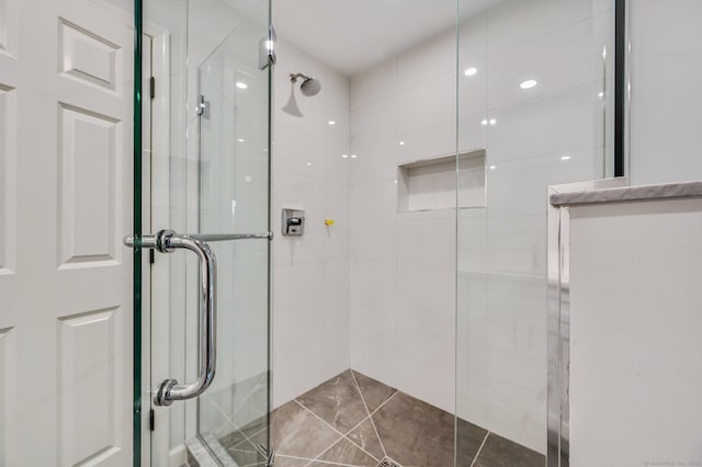 bathroom featuring a shower with shower door