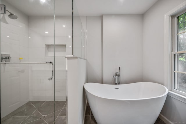 bathroom featuring shower with separate bathtub