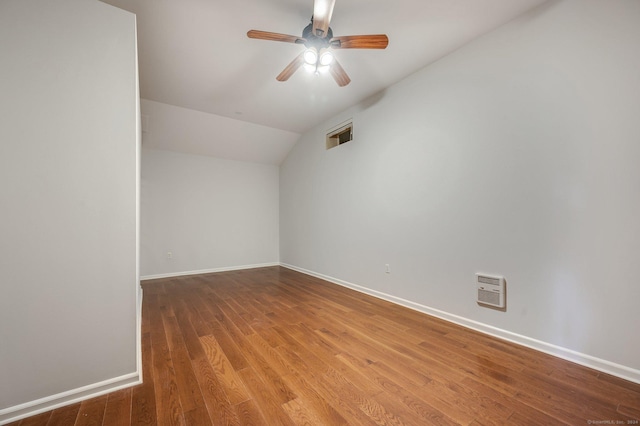 empty room with hardwood / wood-style flooring, lofted ceiling, and ceiling fan