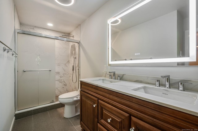 bathroom with vanity, an enclosed shower, and toilet