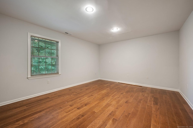 spare room featuring wood-type flooring