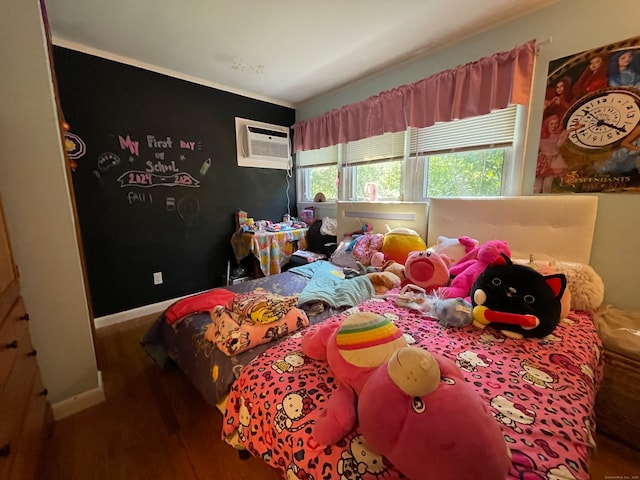 bedroom featuring an AC wall unit and wood-type flooring