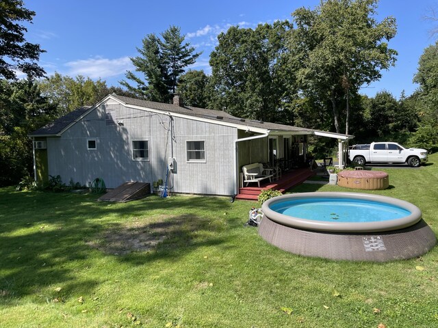 rear view of house featuring a yard